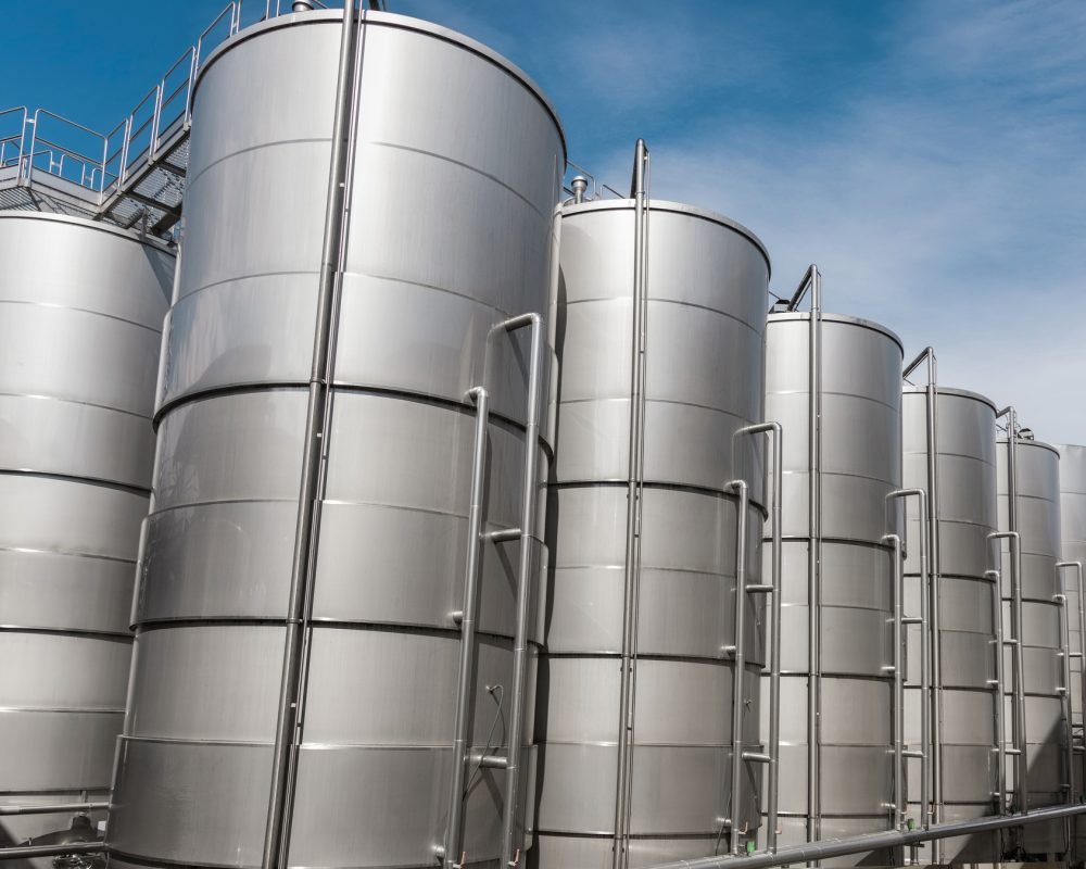 Steel tanks for wine fermentation at a modern winery. Large brewery silos for barley or beer